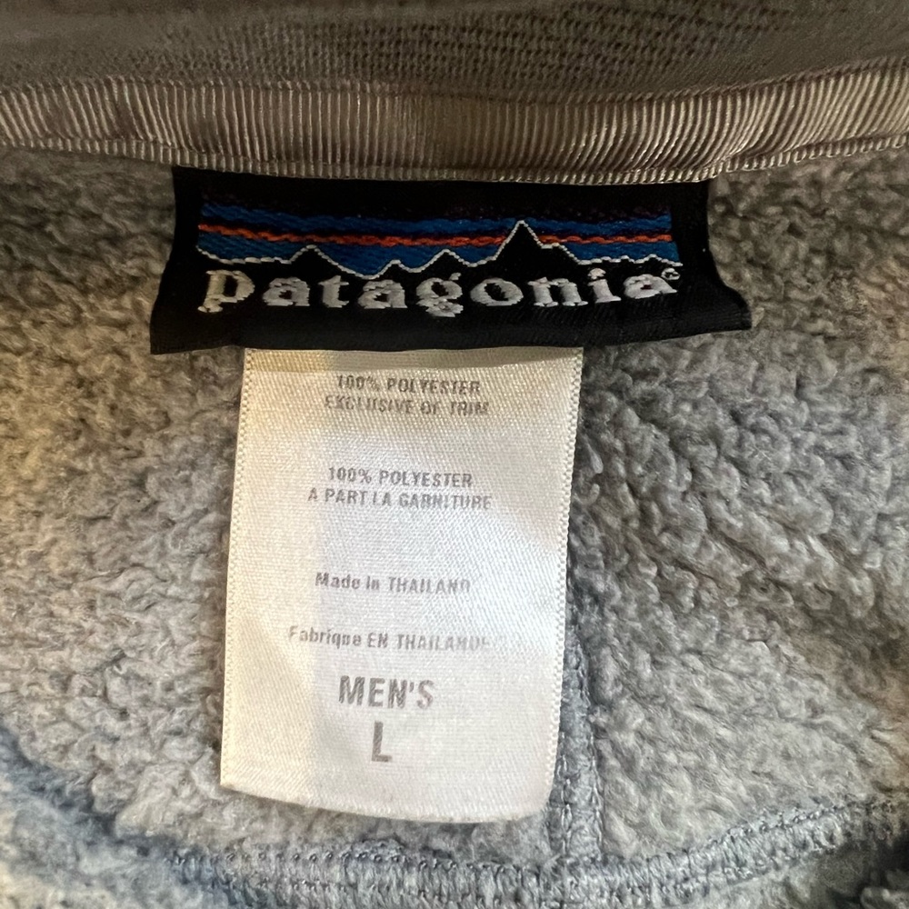 A grey Patagonia sweater with zipper and chest pocket. Comfy and warm. Large.